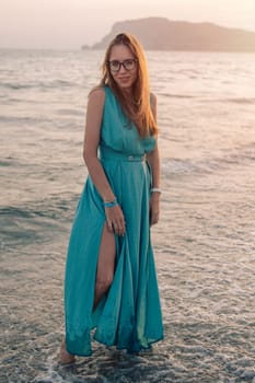 A woman in a flowing green dress poses on a pier by the sea at sunset, with a Turkey flag waving in the background.