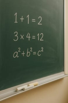 Chalkboard with written math equations including basic arithmetic and Pythagorean theorem. Ideal for educational content, math tutorials, school materials, or classroom visuals