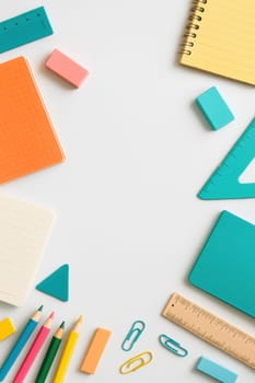 School stationery flat lay with pastel notebooks, pencils, erasers and rulers on white background. Ideal for back-to-school content, educational visuals, study themes or minimalist layouts