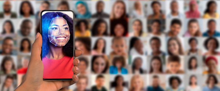 A hand holds a smartphone displaying a facial recognition feature. Behind, a diverse collage of faces shows various expressions and identities, symbolizing modern identification technology.
