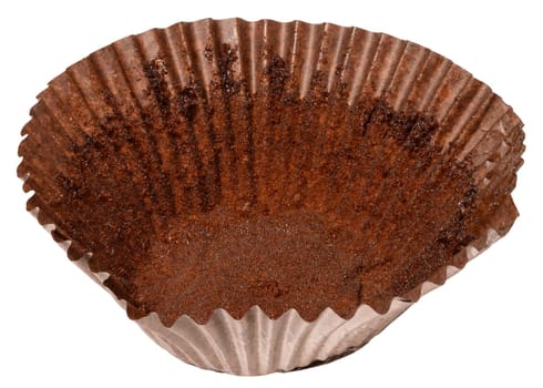 Close up of empty brown paper cupcake or muffin tin with chocolate residue, isolated background