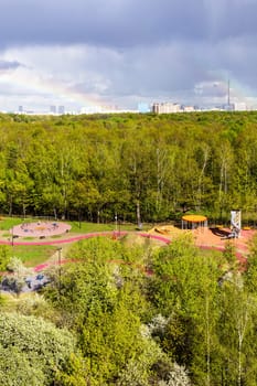sunlit playground near city park after rain on sunny spring day