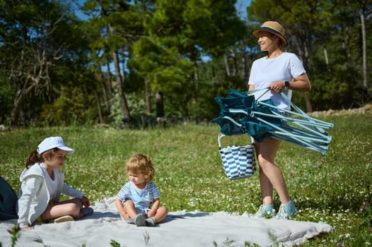 A family enjoys a serene picnic in a picturesque outdoor location, showcasing leisure and bonding in a natural, inviting atmosphere.