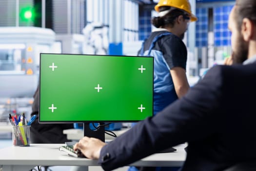 Engineer in photovoltaics factory reviewing system logs on green screen computer to identify operational inefficiencies. Photovoltaic plant worker adjusting manufacturing parameters on chroma key PC