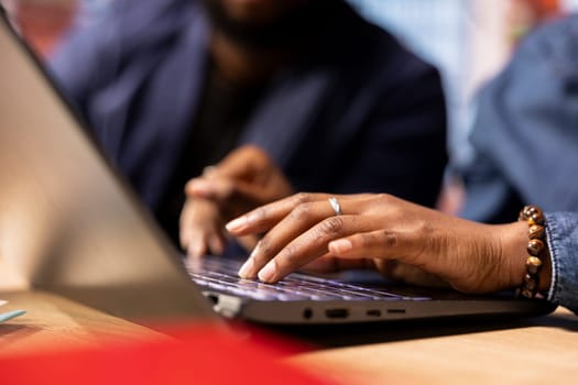 African American man and woman at home office analyzes online business trends, using teamwork and technology to manage their freelance careers and boost tasks efficiency. Networking.