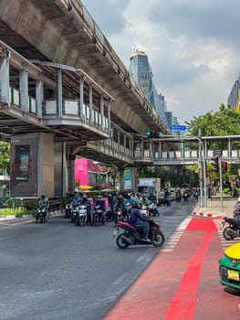 Bangkok, Thailand - November 11, 2024: Metropolis urban traffic on a multiple lane highway in town, mode of transport in the crowded city center. Motorcycles on the freeway in busy town.
