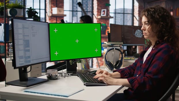 Woman coding in AI startup office using mockup PC, building scalable solutions for businesses. AI industry startup technician leveraging machine learning technology on green screen computer, camera A