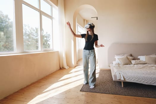 A person engages with virtual reality technology in a bright, cozy room filled with natural light during the day. The atmosphere is calm and inviting.