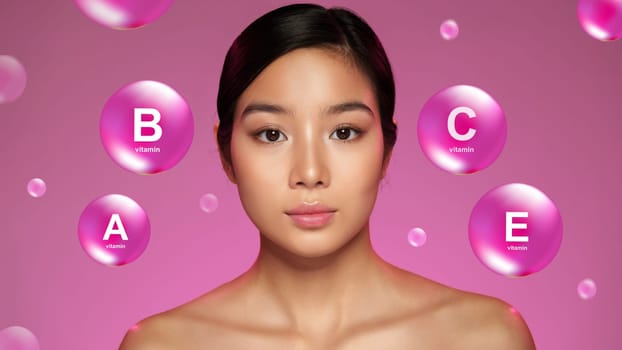 A young woman with radiant skin poses against a pink backdrop, highlighting the skincare benefits of vitamins B, C, and E through floating bubbles that enhance her beauty.