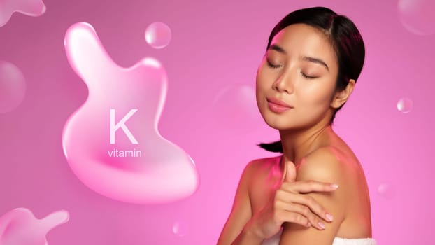 A woman gently applies a skin care product containing vitamin K, emphasizing its benefits for skin health. The vibrant pink backdrop enhances the focus on the product.