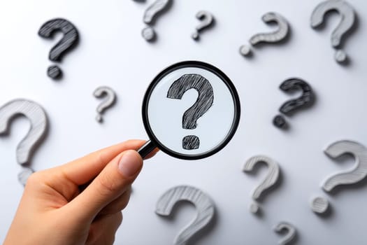 Question Mark and Root Cause Analysis Concept. A hand holding a magnifying glass over a large question mark surrounded by smaller ones on a blue background, symbolizing analysis and problem-solving..