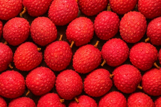 AI generated top view of fresh lychees with water droplets under bright daylight showing vibrant red skins and clean textures perfect for tropical fruit freshness and summer vibes