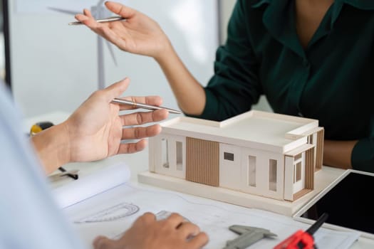 Architects collaborating on a sustainable building model, emphasizing environmental responsibility and innovative design.