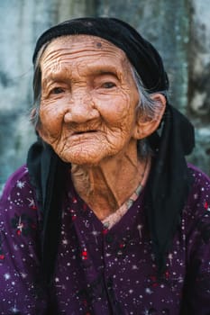 Portrait of an old elderly Asian Vietnamese woman in a village in Asia in Vietnam. Tam Thanh, Quang Nam province, Vietnam - April 10, 2025
