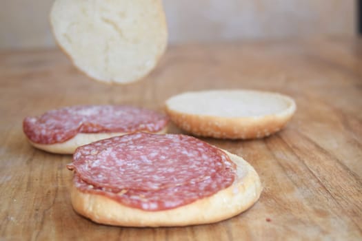 sandwich rolls cut in half and filled with slices of salami