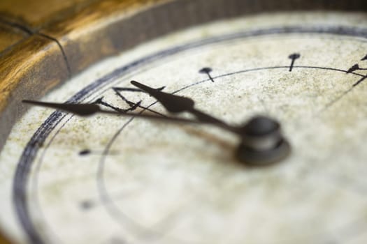 A detailed close-up image of a vintage clock face with ornate hands, showcasing the intricate design and aged texture of the timepiece