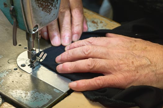 a person whose occupation is making fitted clothes such as suits, pants