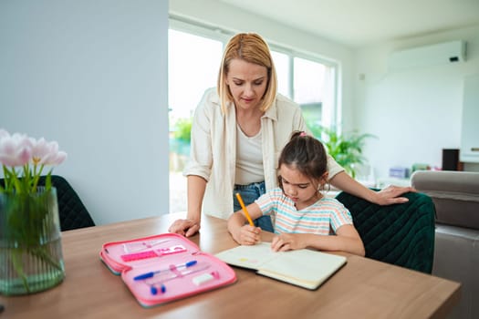 Child learns and writes with mother s guidance at home.