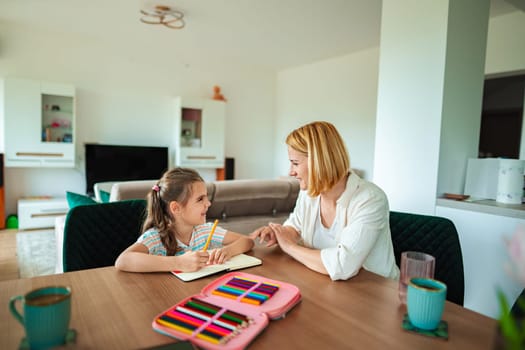A mother and daughter share a joyful learning experience.