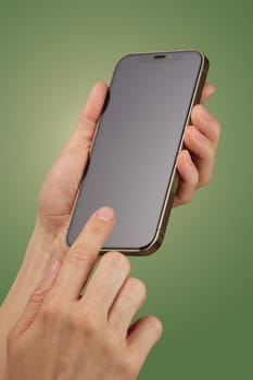 female hand holding and clicking , typing on smartphone screen isolated on green background, mockup , woman using smart phone