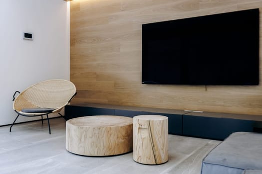 Imagine a cozy living room featuring two beautifully crafted wooden tables, along with a sleek flat screen television mounted stylishly on the wall