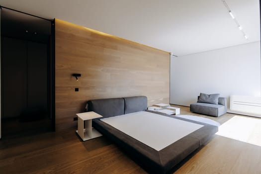 Imagine a beautiful bedroom that features a large, inviting bed, complemented perfectly by a stylish wooden wall that adds warmth and character