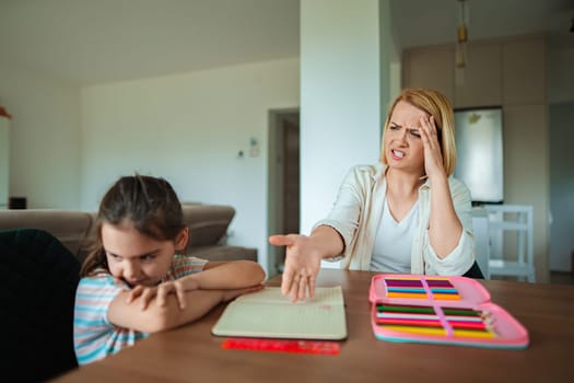 Child sits quietly parent shows stress and concern.