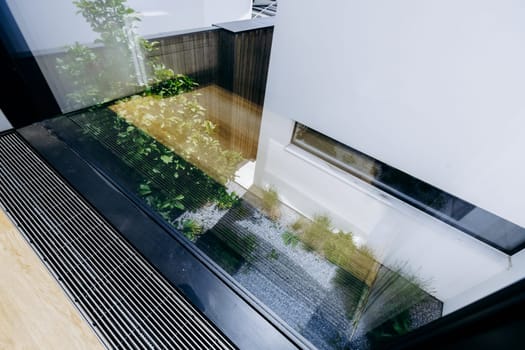 This is an observation of how a buildings image is captured in the gleaming surface of a glass window nearby