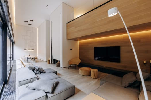 A beautifully designed living room featuring a comfortable couch and a large television mounted on the wall for entertainment purposes
