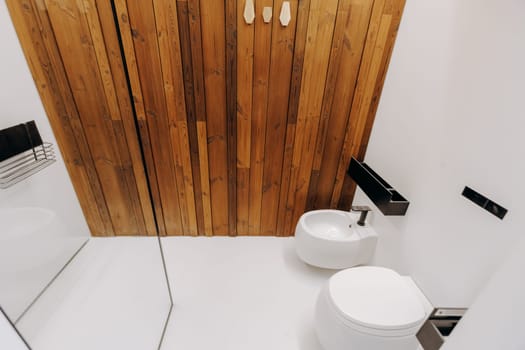 A bathroom equipped with essential amenities including a toilet, a sink for washing hands, and a mirror for grooming purposes