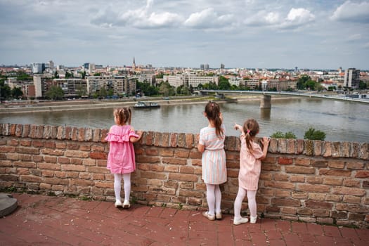 Three girls gaze over the Danube from historical Petrovaradin.