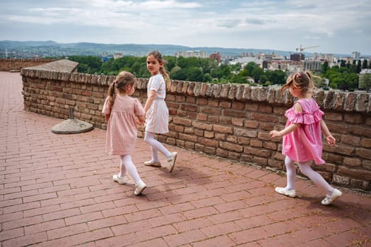 Joyful children enjoy a playful day at Petrovaradin fortress.