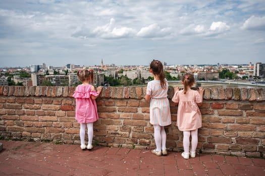 Young girls admire the panoramic skyline of Novi Sad.