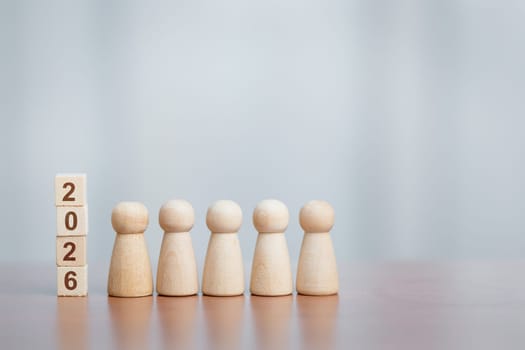 Five wooden figurines beside stacked blocks showing '2026'. Concept of future planning, teamwork, goal setting, leadership, and new year vision.