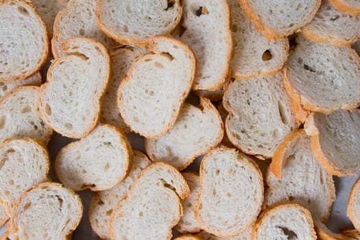 Sliced french baguette overhead view. Bread texture and pattern.