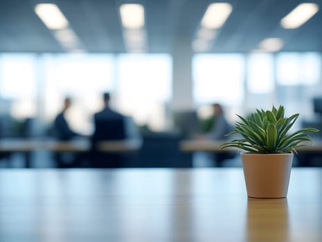 AI generated image of a small green plant in a pot placed on a clean office desk. Blurred background with people and lights reflects a calm, modern, and eco-friendly professional workspace.