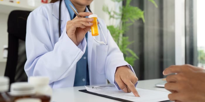 A healthcare professional discusses a prescription with a patient, emphasizing communication and patient understanding.