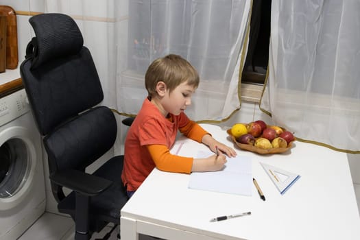 Child writing on notebook sitting on an ergonomic chair at home