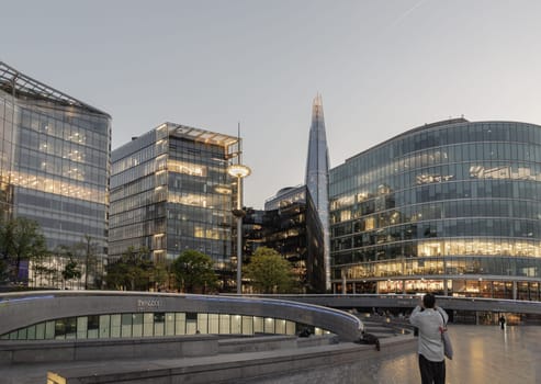 London, UK - Apr 27, 2025 - The scoop, an amphitheatre next to the GLC building, at More London with the Shard and other Modern glass buildings behind. The Stunning view after sunset in City of London. use it as your Wallpaper, Poster and Copy space. Selective focus.