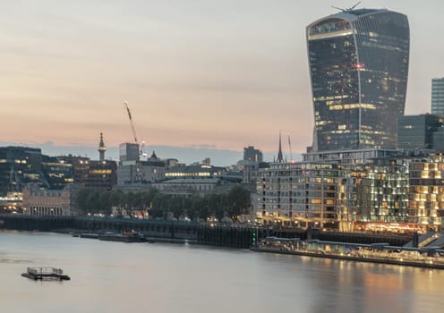 London, UK - Apr 27, 2025 - The Stunning view of The modern 20 Fenchurch Street (Walkie-Talkie building) and River Thames after sunset in City of London. use it as your Wallpaper, Poster and Space for text. Selective focus.