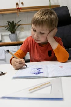 Child practicing writing and drawing skills, developing creativity and fine motor abilities in a comfortable home environment