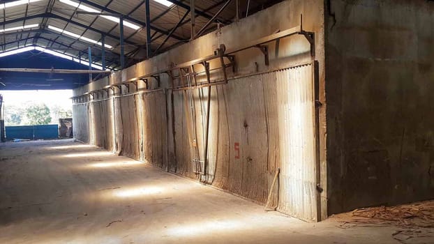 plywood processing plant showcasing Industrial Warehouse Interior with Stacks of Materials and Machinery, warehouse featuring industrial equipment, materials, and wooden pallets, highlighting productivity and organization.