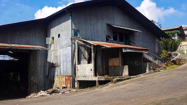 plywood processing plant showcasing Industrial Warehouse Interior with Stacks of Materials and Machinery, warehouse featuring industrial equipment, materials, and wooden pallets, highlighting productivity and organization.
