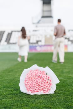 bouquet of roses on the lawn of the football field. High quality photo