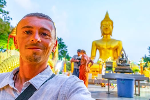 Handsome Man Tourist at the Wat Phra Yai Big Golden Buddha Temple on Phra Tamnak Mountain Hill in Pattaya Bang Lamung Amphoe Chon Buri Thailand.