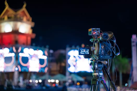 Professional video crew covering live event on stage. Expertise in movie production television streaming using multimedia equipment. Industry creativity in cinematography give me.