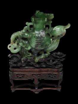 Elaborate 18th-19th century Chinese vase carved from deep green jade in the shape of a heavenly rooster. Intricate details, mounted on a wooden stand. Symbol of auspiciousness.