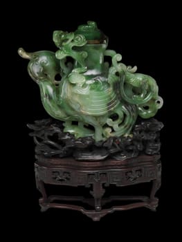 Elaborate 18th-19th century Chinese vase carved from deep green jade in the shape of a heavenly rooster. Intricate details, mounted on a wooden stand. Symbol of auspiciousness.