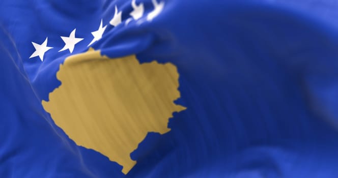 Close-up of Kosovo national flag waving in the wind. Six white stars above a golden map of Kosovo in a blue field. 3d illustration render. Rippling textured fabric. Selective focus
