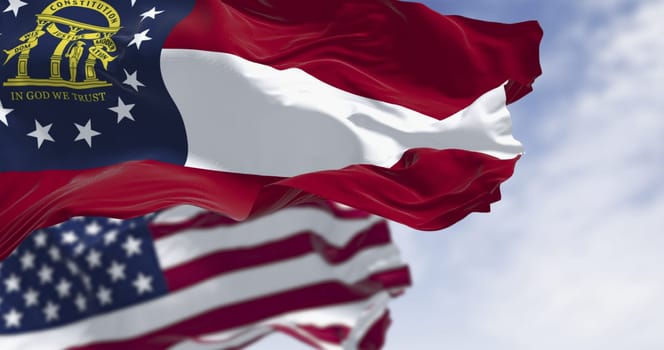 Flags of Georgia and United States waving in the wind on a clear day. Georgia is a state in the southeastern US. US federate state. 3d illustration render. Fluttering textile